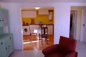 een keuken en eetkamer met een tafel en stoelen bij An out of time apartment near the beach in São Bernardino in Atouguia da Baleia