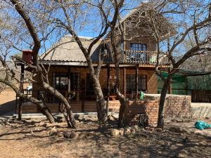 a large house with a balcony on top of it at Mopani Villa in Marloth Park