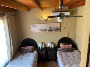 two beds in the corner of a room at Mopani Villa in Marloth Park +41 photos