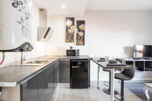a kitchen with a sink and a counter top at LU&CIA EL CARMEN in M&aacute;laga