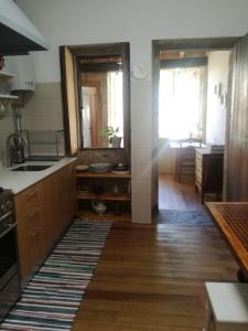 a kitchen with a sink and a mirror at Casa de Guadalupe in Braga +43 photos
