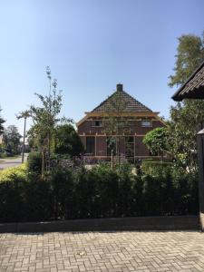 a large brick house in front of a building at B&B en Appartementen Triënte in Buinen