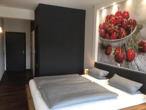 a bedroom with a bed with a bowl of tomatoes on the wall at Gasthof Kirschtraum in Sontra