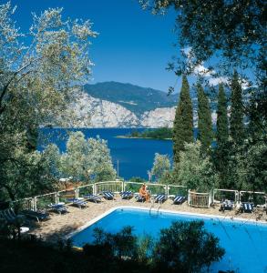 a swimming pool with a view of a lake at Hotel Villa Orizzonte in Malcesine