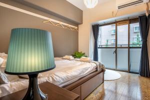 Postel nebo postele na pokoji v ubytování Uhome Akihabara Apartment 3