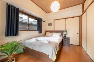 Postel nebo postele na pokoji v ubytování Uhome Akihabara Apartment 3