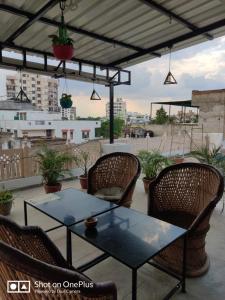 a table and chairs on the roof of a building at Madhav Guest House in Jaipur