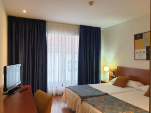 Ліжко або ліжка в номері Hotel Suite Camarena
