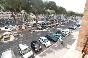 a parking lot with a lot of cars parked at Affittacamere Vimercati 30 in Rome