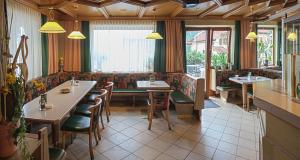 a dining room with tables and chairs in a restaurant at Monika Landerl Café Landerl in Matrei in Osttirol