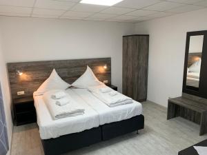 a bedroom with a bed with two towels on it at Casino Hotel Hamm in Hamm +18 photos