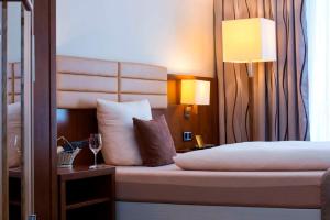Postel nebo postele na pokoji v ubytování Hotel Simon's Plaza