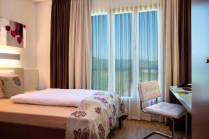 Postel nebo postele na pokoji v ubytování Hotel Simon's Plaza + 37 fotografií