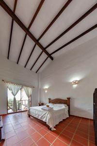 a bedroom with a large bed in a room at Casa de Teja Barichara in Barichara