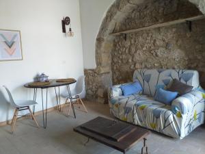 ein Wohnzimmer mit einem Sofa und einem Tisch in der Unterkunft Gibbesi country farm piccolo cottage in Naro