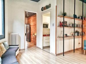 a kitchen with a refrigerator, sink, and cabinets at Rodamon Barcelona Hostel in Barcelona