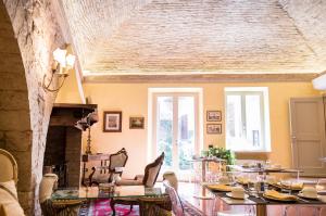 a living room with a table and a fireplace at Brunelli B&B in Assisi