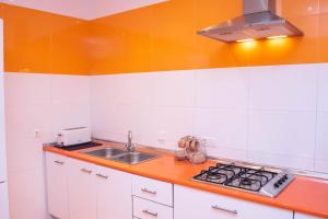 a kitchen with a sink and a stove at Casa Juan Breva in Málaga