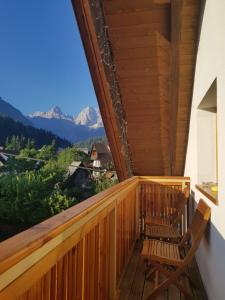 a balcony with two chairs and a view of mountains at Apartments Katja in Kranjska Gora