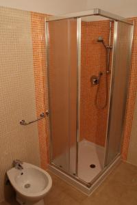 a bathroom with a shower and a toilet at Residence Le Casine in Batignano +10 photos