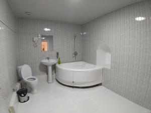 a bathroom with a tub and a toilet and a sink at Carousel in Khiva +56 photos