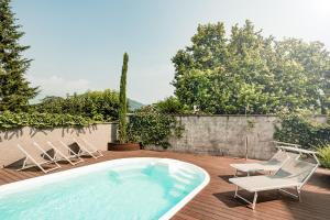 a patio with two chairs and a swimming pool at Hotel Heide Park in Auer