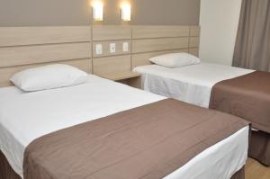 En eller flere senge i et værelse på Executivos Hotel