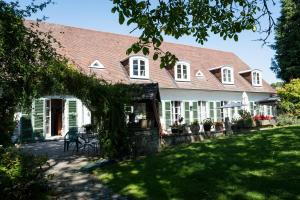 a large white house with a porch and a yard at B&B El Tyu in Écaussinnes-dʼEnghien