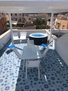 a patio with chairs and a pool on a roof at La casa di fronte la spiaggia di San Vito lo capo in San Vito lo Capo