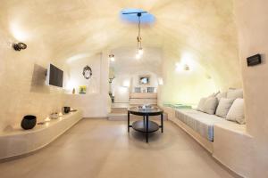 a living room with a bed and a table at Hidden Treasure Suites in Vóthon