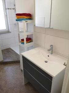 a bathroom with a sink and a mirror at Lüdenscheid-Ferienwohnung de Betzler Weh29-100 in Lüdenscheid +16 photos