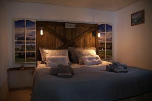 a bedroom with a bed with two towels on it at Romantic Klaksvik apartment in Klaksvík