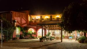 a courtyard of a house at night with a table at Agriturismo Costiolu in Nuoro