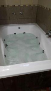 a bath tub filled with water in a bathroom at cascada del bosque in Mar de las Pampas +6 photos
