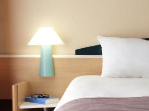 Postel nebo postele na pokoji v ubytování Hotel ibis Leiria Fatima