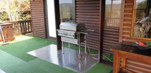 a grill on the outside of a house with a porch at House 53 Sodwana Bay Lodge in Sodwana Bay