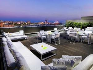 a living room filled with tables and chairs at H10 Port Vell 4* Sup in Barcelona