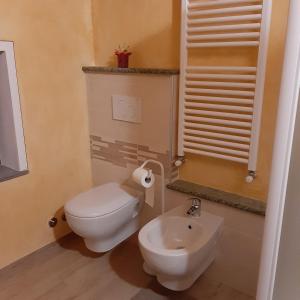 a bathroom with a white toilet and a sink at Maison Venoir1 in Aymavilles +32 photos