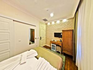 Postel nebo postele na pokoji v ubytování Nusretbey Hotel