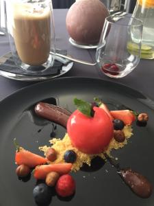 a plate of food on a table with a drink at Economy rooms for 2-4 people in Anykščiai