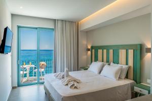 a bedroom with a bed with a view of the ocean at Samaria by the Sea in Hora Sfakion