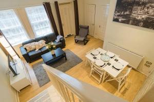 an overhead view of a living room with a table and chairs at 2BR Grassmarket Apartment with Castle View in Edinburgh