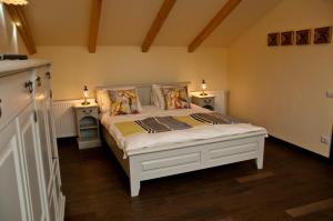 a bedroom with a white bed with two night stands at Arina Apartments in Braşov