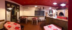 a restaurant with two tables and a counter in a room at Locanda Fuoriporta in Cantagrillo