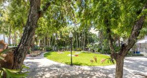 a park filled with trees and shrubs at Selina Miami River in Miami
