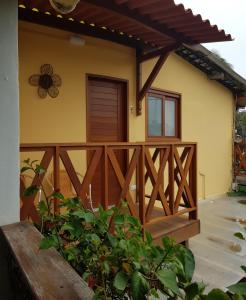 a wooden fence in front of a house at Paranambuca Pousada in Porto De Galinhas