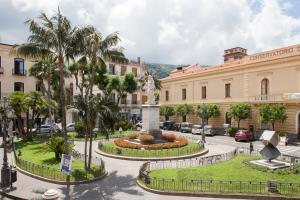 a city square with a statue in front of a building at Villa Elisa Holiday Home in Sorrento