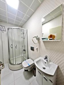 a bathroom with a shower and a toilet and a sink at Nusretbey Hotel in Istanbul