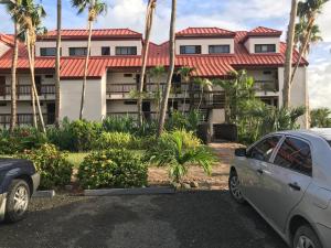 a building with a car parked in front of it at Ocean Front Sapphire del Mar B-107 in St Thomas