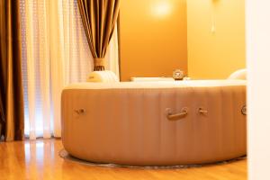 a large suitcase sitting on the floor in a room at Jacuzzi studio apartman Mare's in Zagreb